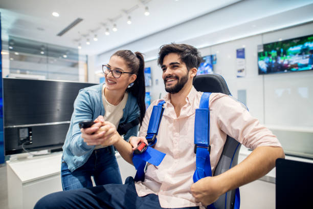 istock Multiracial couple having fun with VR goggles while boy sitting in the chair in the tech store. Customer's service. Shopping time. 947574688