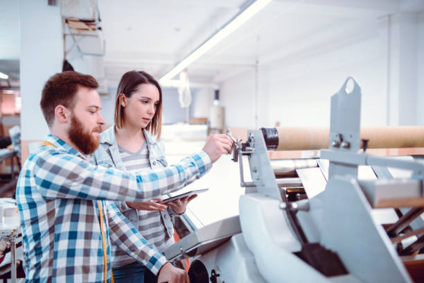 istock Team Working in Textile Factory on 3D Clothing Printing 947574896