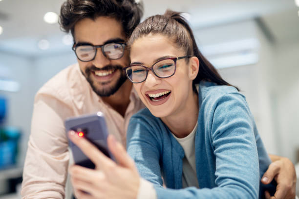 istock Young satisfied stylish charming couple testing the new model of 947578696