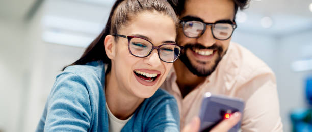 istock Young satisfied stylish charming couple testing the new model of 947584398