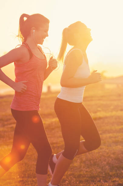Two women running together in the park.