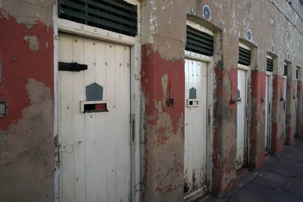 Abandoned isolation cell doors at Constitution Hall in Johannesburg, South Africa.  Main focus on closest door.
