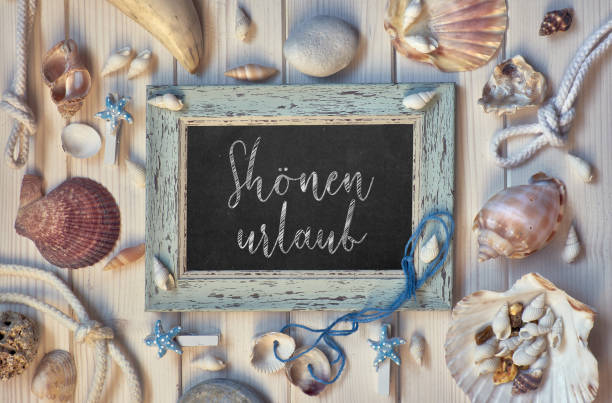 istock Blackboard With Maritime Decorations on light wood, text in German 947587908