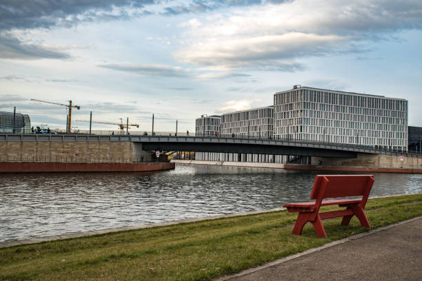 A red bench in front of some modern buildings in Berlin