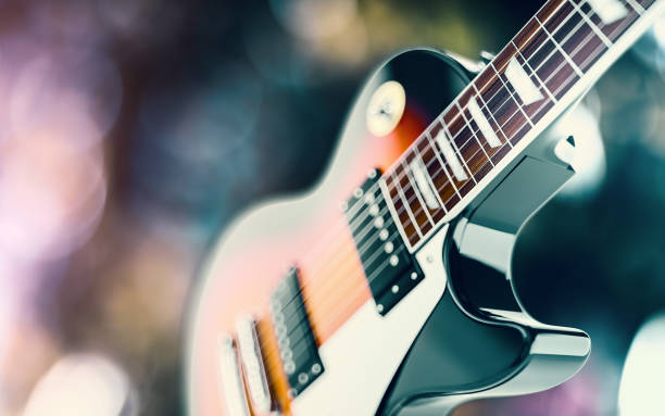 istock Close up shot of a guitar, over blured lights background 947592032