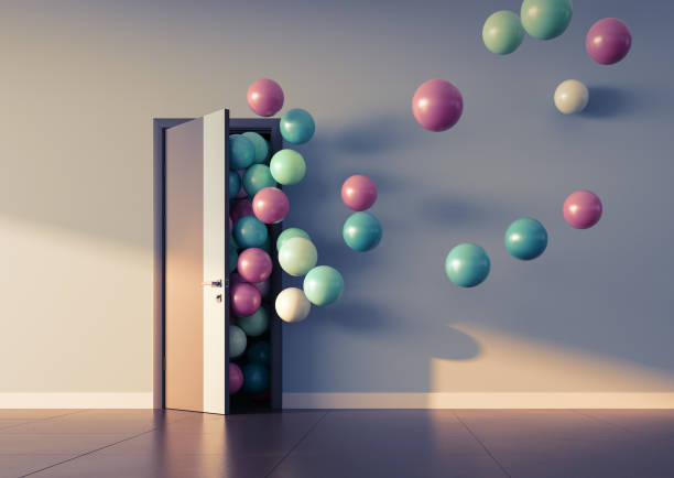 istock Balloons fly away through open door 947592218