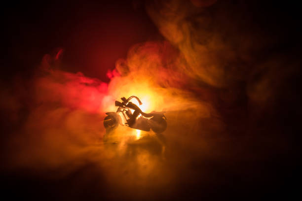 istock High power motorcycle chopper. Fog with backlights on background with man rider at night. Empty space 947598230