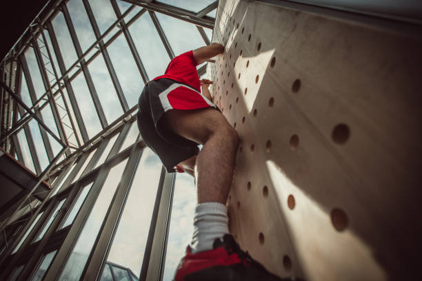 istock Young athlete climbing up in a bouldering gym 947601366