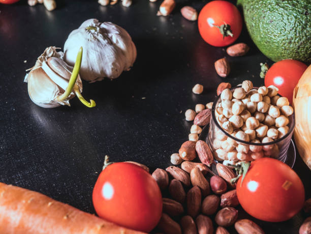 istock close up fresh garlic with vegetables and seeds on the black surface 947608148