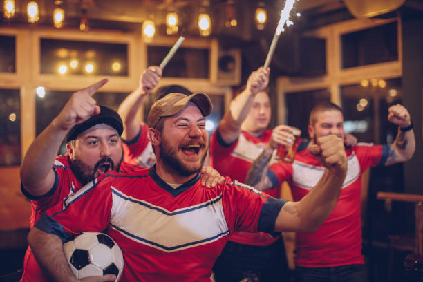 istock Group of fans cheering in pub 947628124