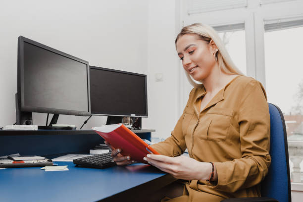 istock Smiling woman holding paper 947638846