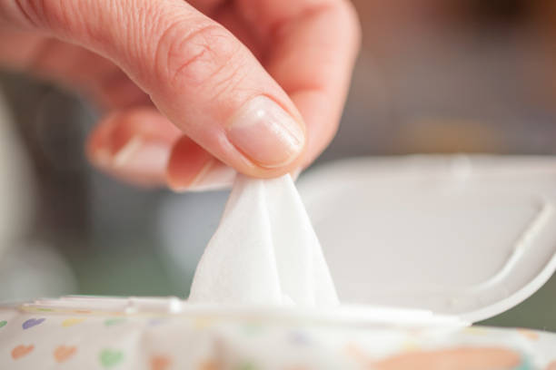 istock Hand picked a wet wipes in package box, Wet wipes in a woman's hand 947648184