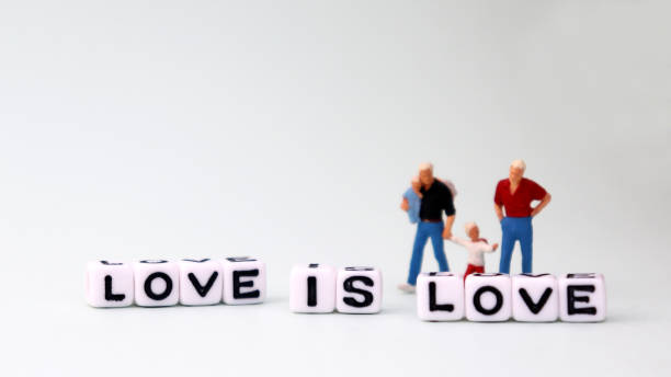 istock Homogeneous marriages and parenting concepts. White square cube with text 'LOVE IS LOVE' 947648476