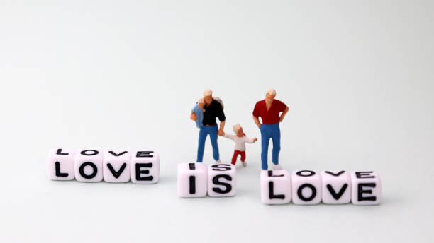 istock Homogeneous marriages and parenting concepts. White square cube with text 'LOVE IS LOVE' 947648516