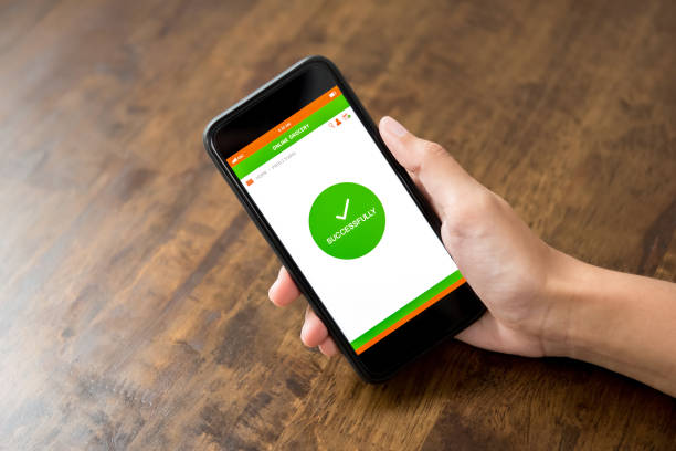 istock Hand holding smartphone showing successfully confirmation text on screen after shopping online 947648830