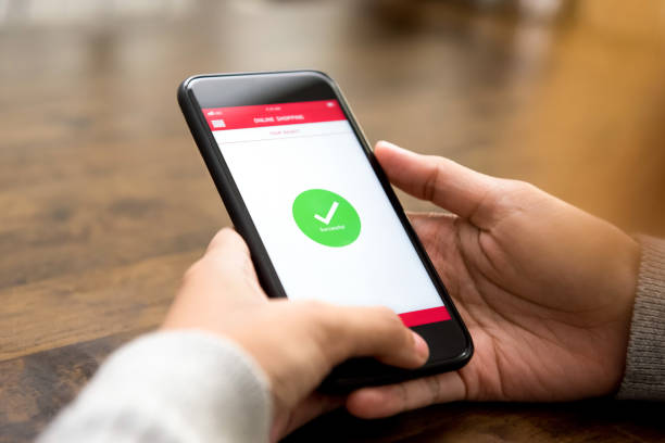 istock Successful online shopping confirmation sign appears on mobile phone screen 947648836