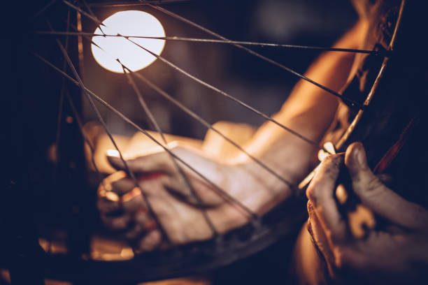 One man, repairing a bicycle in his work shop, part of.
