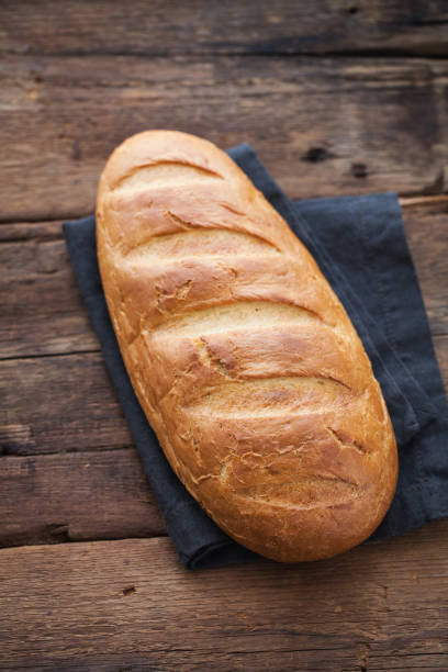 istock Fresh bread on wooden table. Top view 947649286
