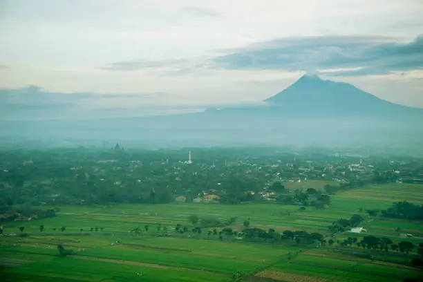 Beautiful landscape of mount Merapi near Prambanan temple at misty morning in Yogyakarta, Indonesia