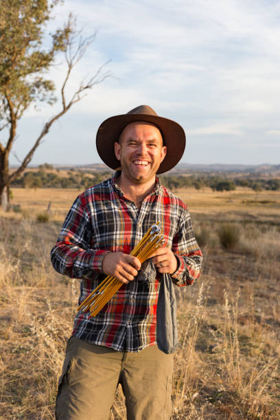 istock Smiling hiker laughs as he holds some tent poles 947655924