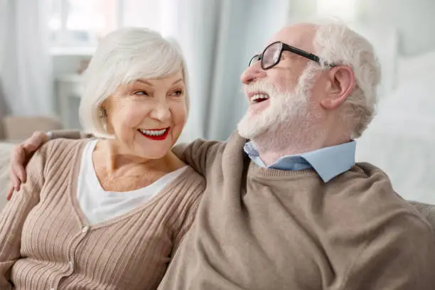 Photo of Cheerful elderly man hugging his wife