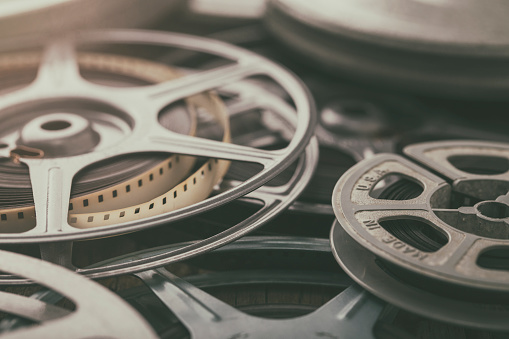 Vintage 8mm home movies on film reels with film leaders and spools.