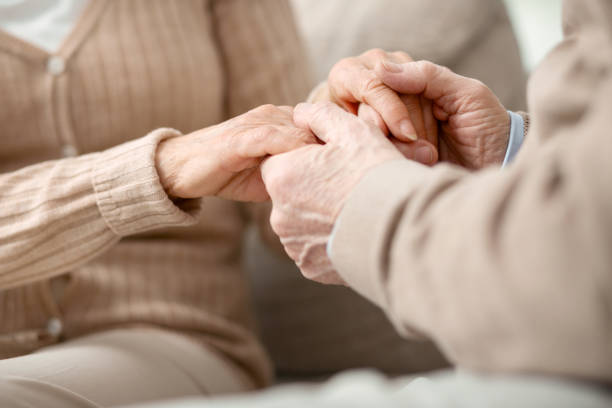 istock Nice aged man holding hands of his wife 947659740