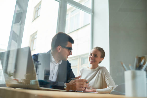 istock Positive enterprising team discussing business ideas 947663820