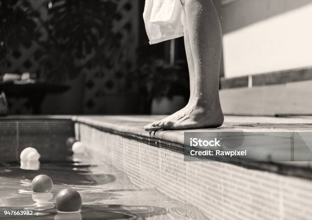 Woman Standing By A Swimming Pool Stock Photo - Download Image Now - Black And White, Swimming Pool, Adult