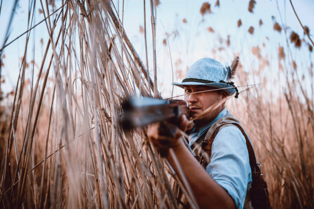 istock Young Hunter With Traditional Clothing Shooting With Rifle 947664370