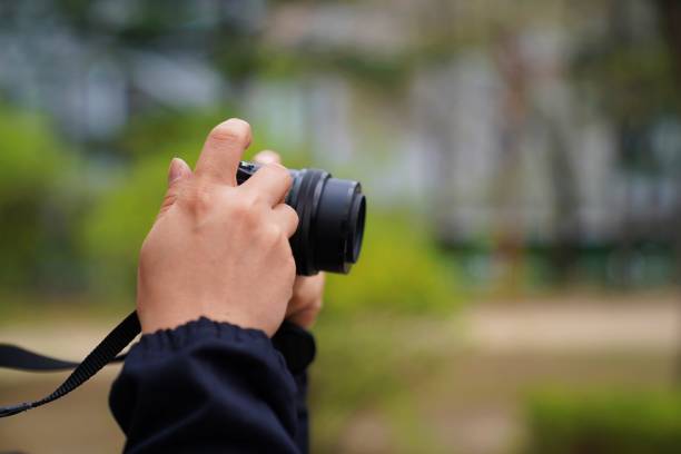 istock A hand holding a snapshot with a digital camera. 947667144