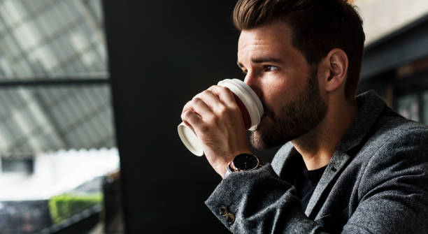istock Side view of man drinking hot coffee 947671040