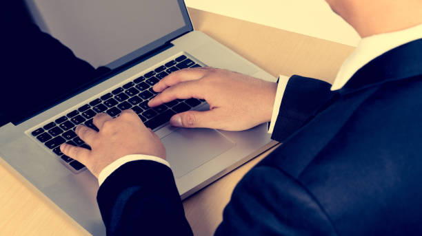 istock Business man working in front of a laptop to work in the office, the document plan summary report. 947671178
