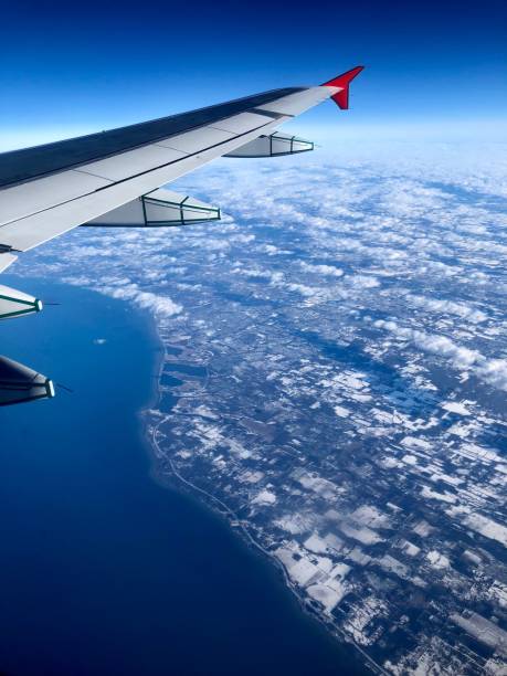istock Flying over a lake and a snowy countryside. 947673638