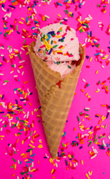 istock Waffle Cone with Strawberry Ice Cream on a Bright Pink Background 947676538