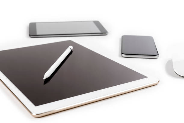 Office table with digital tablet, smartphone, mouse and pencil on isolated pure white background / Laptop and tablet mockup concept. (Selective Focus)