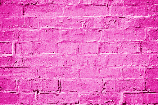 Abstract hot pink, magenta and fuchsia painted brick wall texture background or pattern