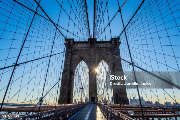 The Brooklyn Bridge With Sunshine Peeking Through Stock Photo - Download Image Now - Brooklyn Bridge, Day, Architecture