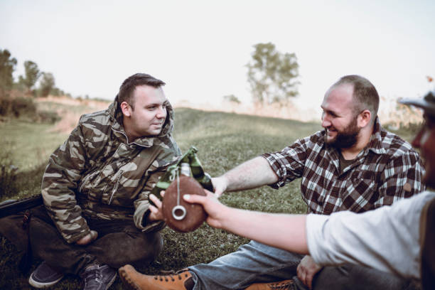 istock Group of Hunters Taking Break from Hunting and Drinking 947683672