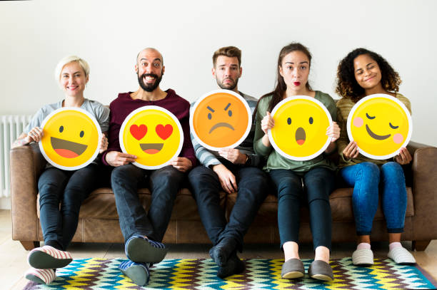 istock Group of diverse people holding emoticon icons 947683680