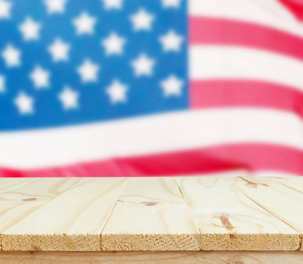 istock wooden table on USA flag with sparklers background 947685774