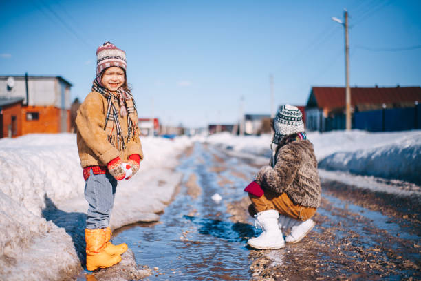 Little girls playing on the street in the village.