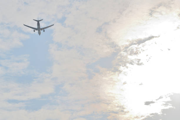 An international airline jet on it's flight path heading for landing at the Hong Kong Airport, it was a cloudy day with blue skies.