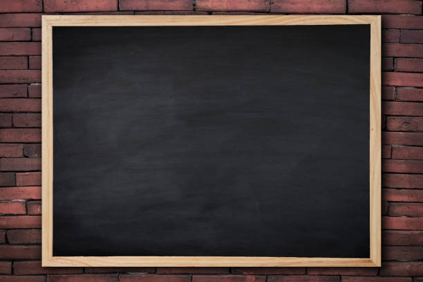 istock Old wooden photo frame on blackboard And Black brick wall for background. texture for add text. 947695392