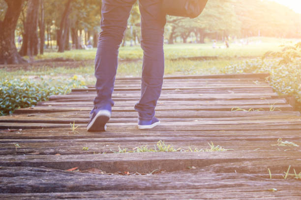 istock man walking in the park. 947703918