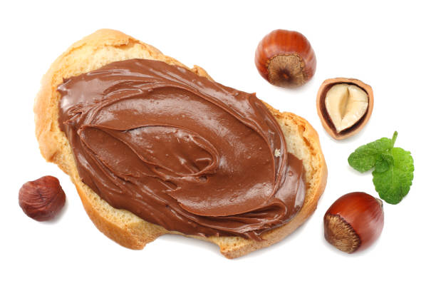 istock Slice of bread with chocolate cream with hazelnut isolated on white background. top view 947704106
