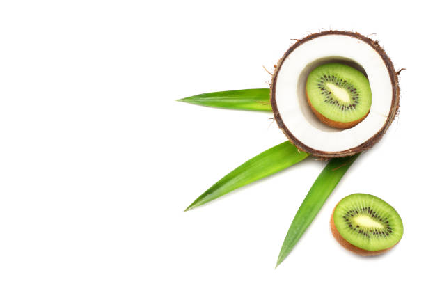 istock Coconut with kiwi and green leaves isolated on white background 947704140