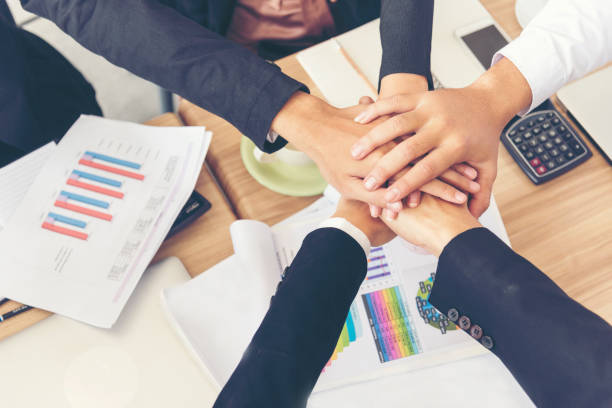 istock Teamwork Concept. Group of young businessman teamwork touching shaking hands together. 947704176