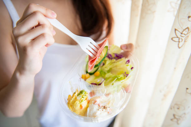 istock Young women eating salad 947710100
