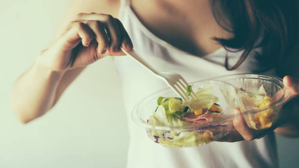 istock Young women eating salad 947710284